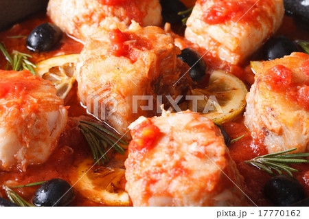 fish in tomato sauce with lemon and olives macro 17770162