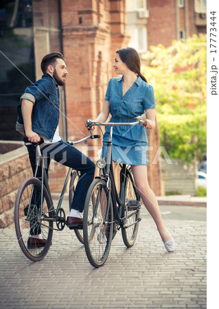 Young couple sitting on a bicycle opposite the 17773444