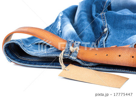 Blue jeans with a leather strap and tag. 17775447