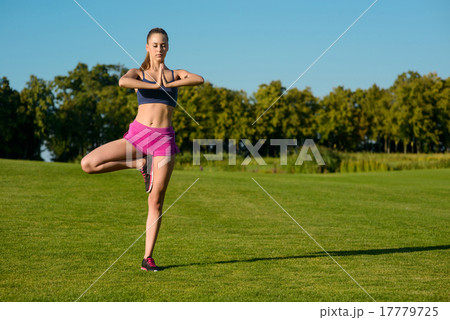 Girl is engaged the pilates on a golf course. 17779725