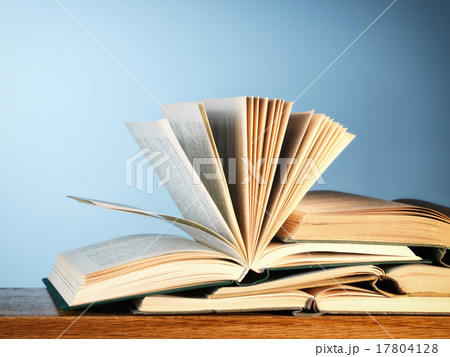 Old open novel books on a wooden table 17804128