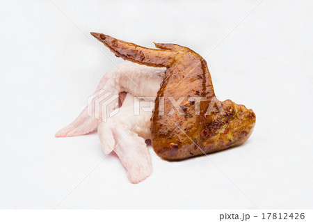 fried and raw chickens on white background 17812426