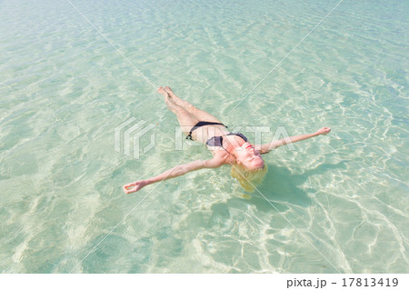 Caucasian lady floating in turquoise sea. 17813419