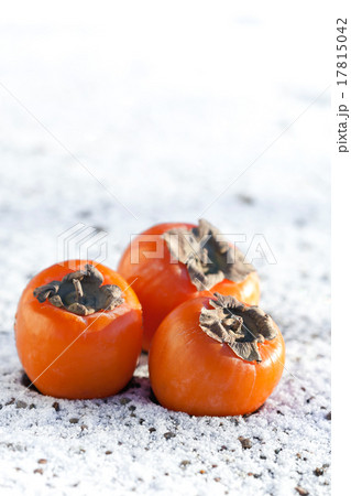 Delicious persimmons on white snow Delicious persimmons on white snow 17815042