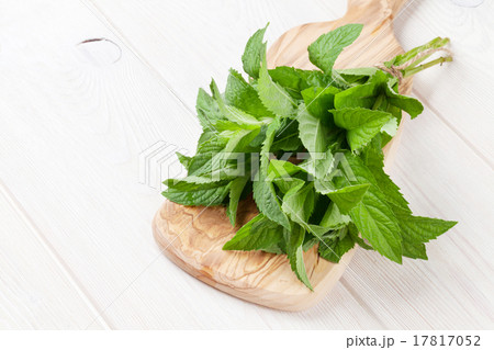 Fresh mint bunch on cutting board Fresh mint bunch on cutting board 17817052