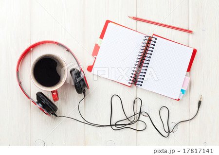 Headphones, coffee cup and notepad on desk 17817141