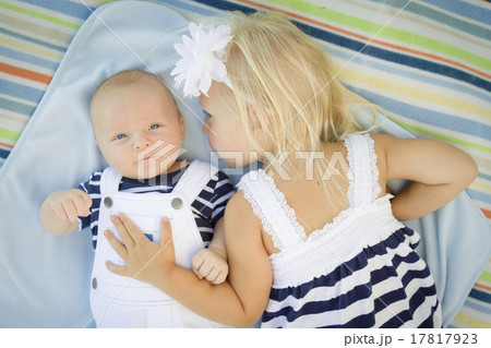 Little Sister Laying Next to Her Baby Brother on Blanket Little Sister Laying Next to Her Baby Brother on Blanket 17817923