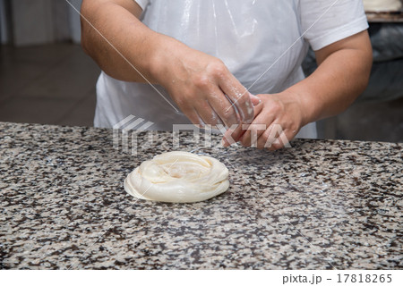 female hands kneading dough and making banitsa 17818265