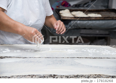 female hands kneading dough and making banitsa 17818268
