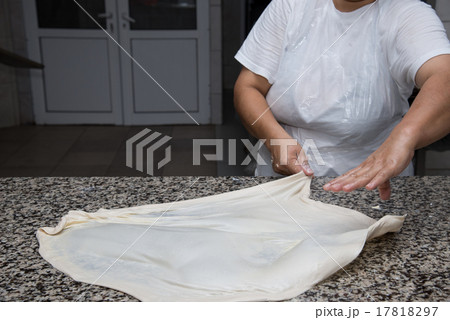 female hands kneading dough and making banitsa 17818297