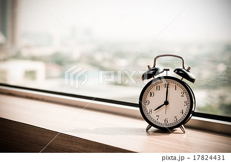 Vintage alarm clock at windows at early morning 17824431