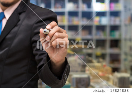 Businessman writing the board on Abstract blurred photo of book 17824888