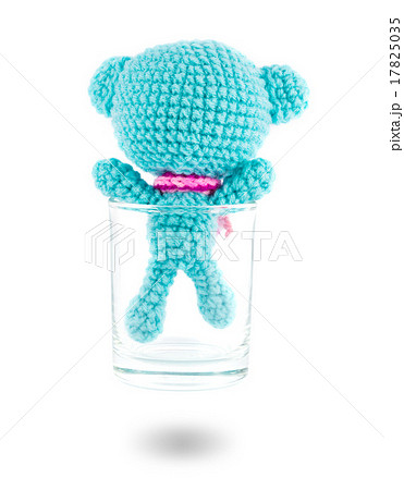 handmade crochet blue bear doll in vodka glass on white backgrou handmade crochet blue bear doll in vodka glass on white backgrou 17825035
