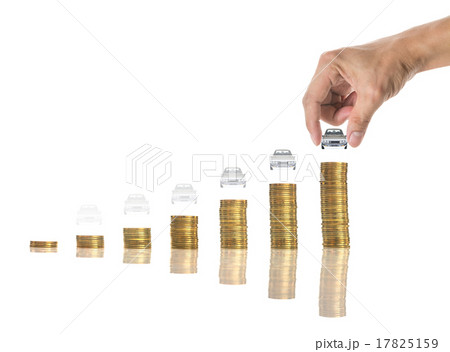 Hand holding a car on the stacks of gold coins on white backgrou 17825159