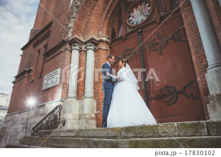 A beautiful bride and handsome groom at church  17830102