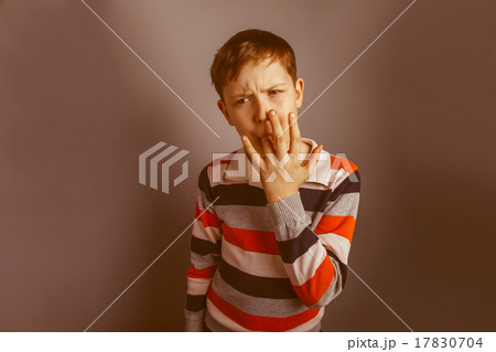 European-looking boy of ten years licks his finger 17830704
