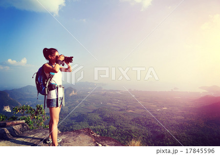 woman hiker photographer taking photo at mountain woman hiker photographer taking photo at mountain 17845596