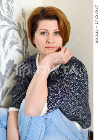 Portrait of adult woman in the room against wall Portrait of adult woman in the room against wall 17850587