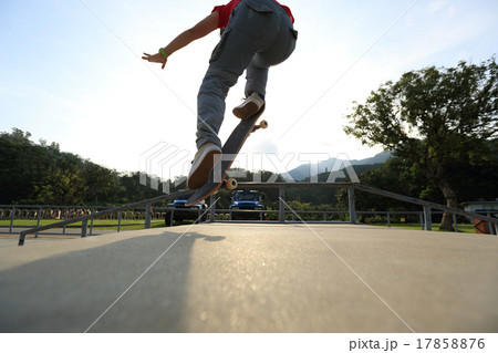 skateboarder legs doing a ollie at skatepark skateboarder legs doing a ollie at skatepark 17858876