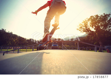 skateboarder legs doing a ollie at skatepark,vintage effect skateboarder legs doing a ollie at skatepark,vintage effect 17858877