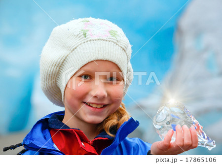Girl with ice piece near Nigardsbreen glacier (Norway) 17865106