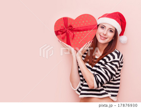girl in Santa Claus hat with gift box girl in Santa Claus hat with gift box 17876930