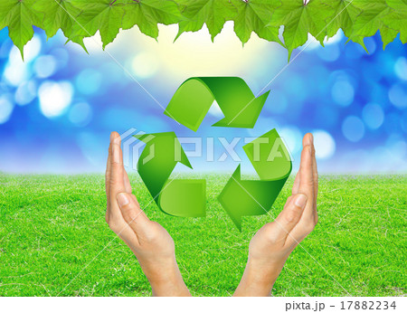RECYCLE sign in hands against green spring. 17882234