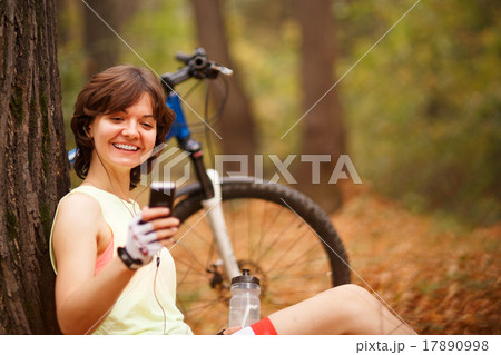 woman with mp3 player in park woman with mp3 player in park 17890998