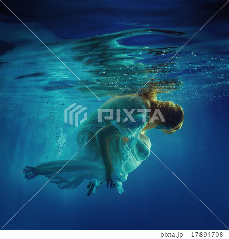 The girl in a beautiful dress under water. The girl in a beautiful dress under water. 17894708