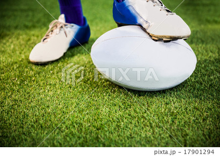 Rugby player posing feet on the ball Rugby player posing feet on the ball 17901294