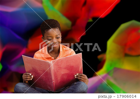 Composite image of cute boy reading book in library 17906014