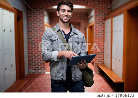 Composite image of student using tablet in library 17906172