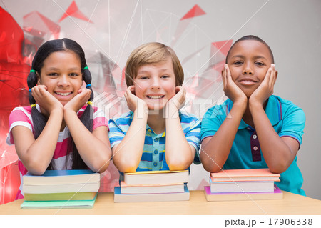 Composite image of cute pupils looking at camera in library Composite image of cute pupils looking at camera in library 17906338