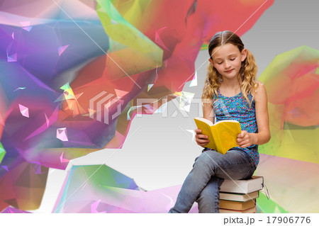 Composite image of cute little girl reading book in library 17906776