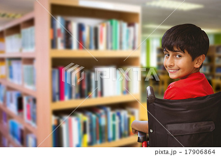 Composite image of boy sitting in wheelchair in school Composite image of boy sitting in wheelchair in school 17906864