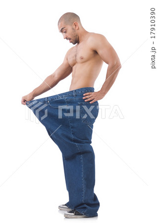 Man in dieting concept with oversized jeans Man in dieting concept with oversized jeans 17910390