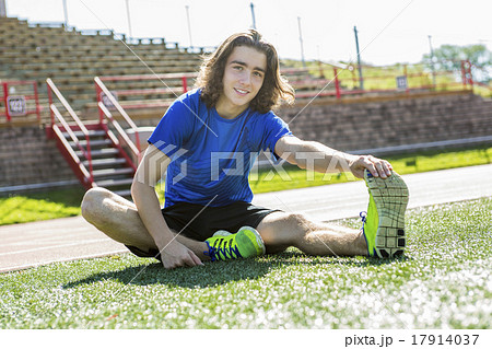 teen boy ready to run outside on a training field teen boy ready to run outside on a training field 17914037