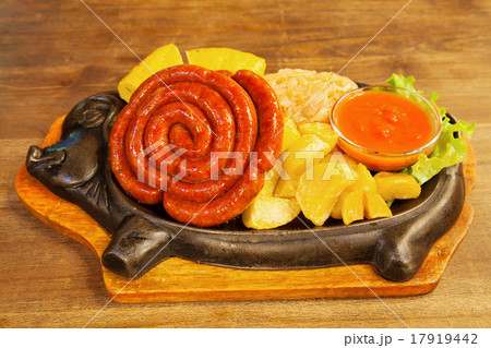 sausage with potatoes, vegetables and hot sauce on a plate sausage with potatoes, vegetables and hot sauce on a plate 17919442