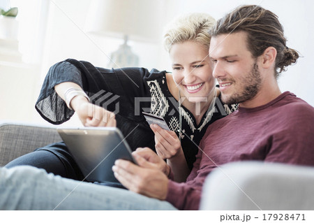 Couple using tablet pc on sofa 17928471