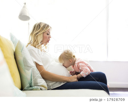 Girl (2-3) kissing belly of mother Girl (2-3) kissing belly of mother 17928709