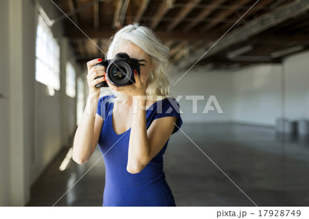Woman using digital camera 17928749