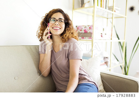 Woman sitting on sofa 17928883