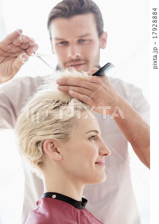Hairdresser cutting woman's hair 17928884
