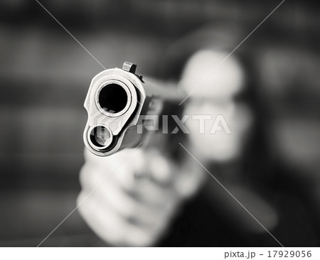 Man with handgun pointing towards camera 17929056
