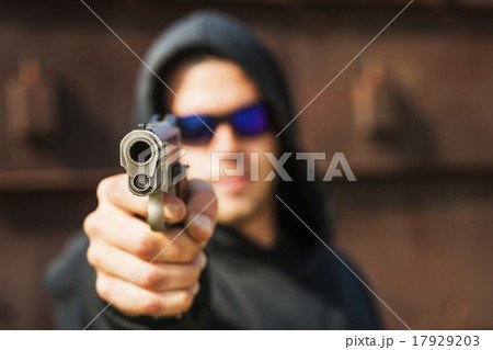 Man with handgun pointing towards camera 17929203