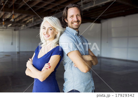 Woman and man standing in warehouse Woman and man standing in warehouse 17929342