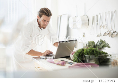 Chef using laptop in kitchen 17929343