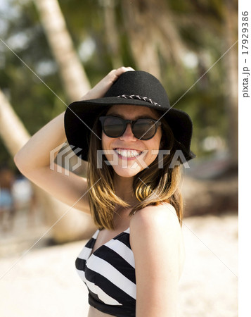 Portrait of woman smiling on beach 17929386
