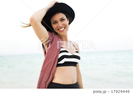 Woman in bikini relaxing on beach 17929440