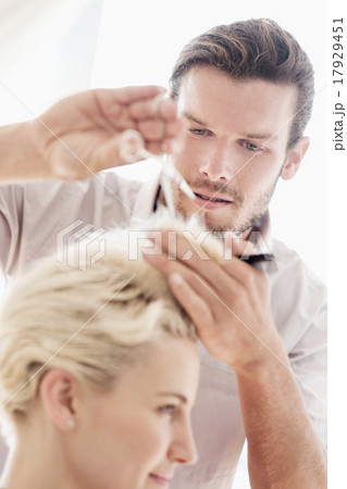 Hairdresser cutting woman's hair 17929451